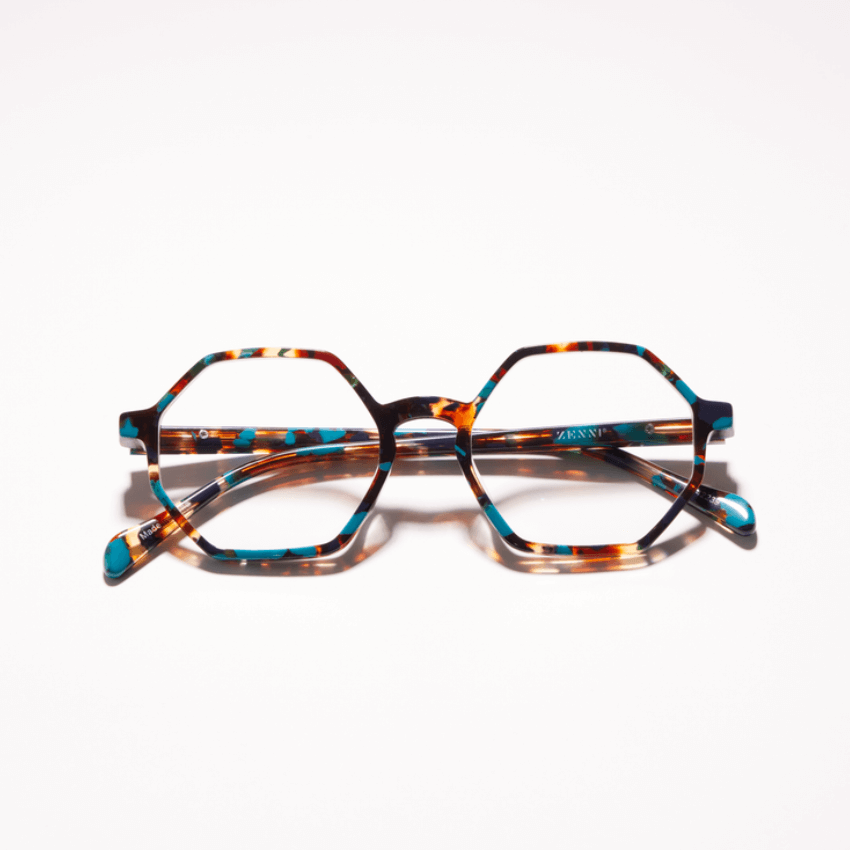 Hexagonal tortoiseshell glasses with turquoise accents, brand "ZENNI" visible on the temple.